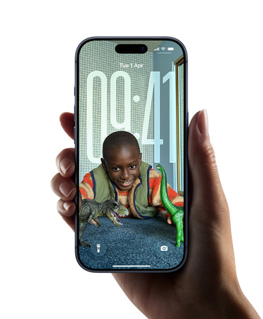 A hand holding an iPhone device which displays the new Liquid Glass design that lets the time dynamically adapt to the image on the Lock Screen